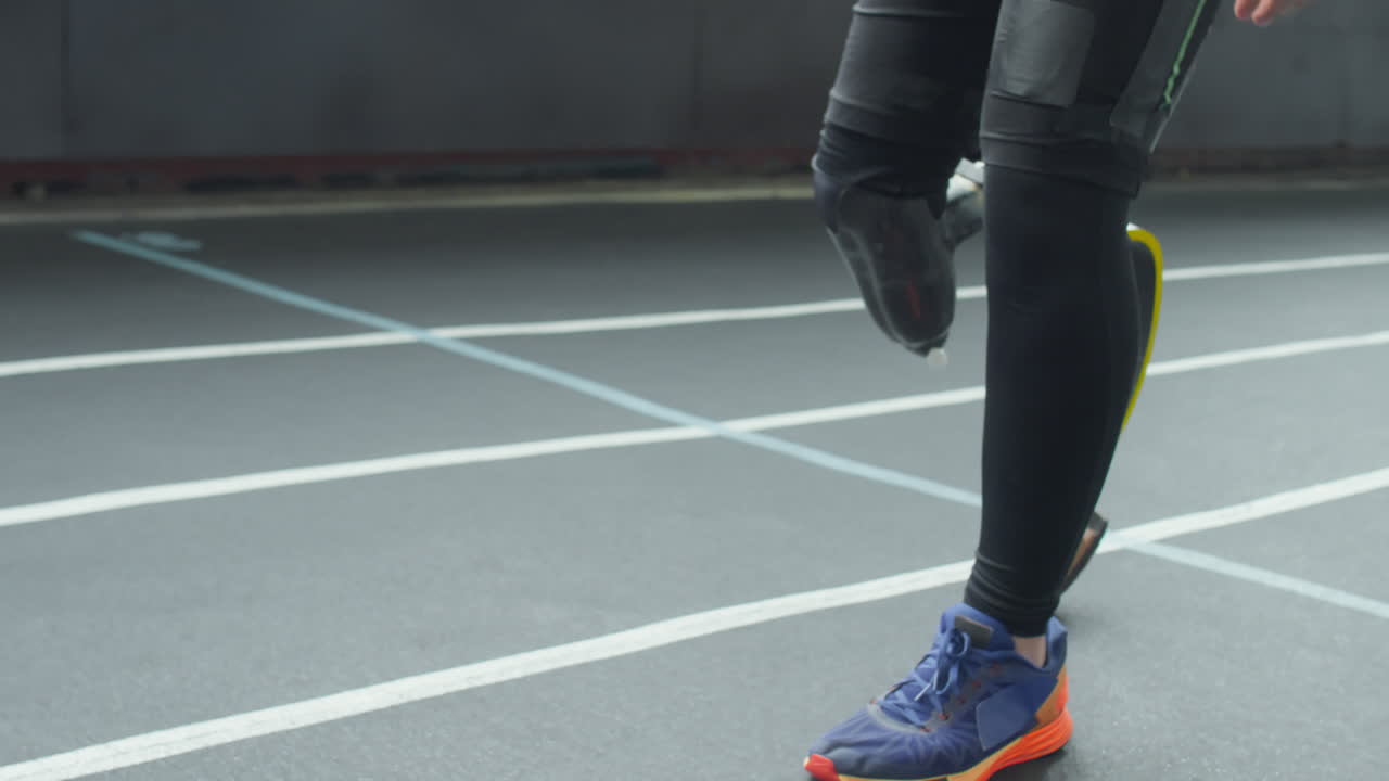 Athlete with Prosthetic Leg Running at Stadium