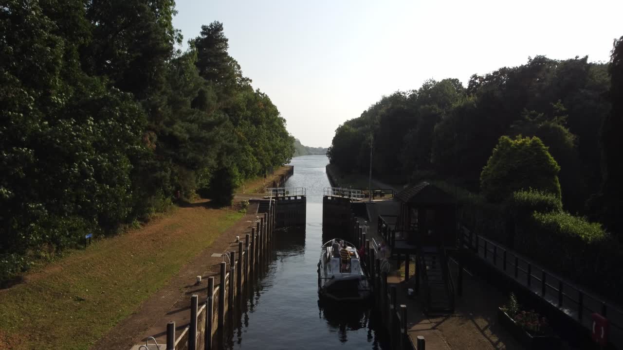 A River Boat leaving a river lock just as the lock doors finish opening. Video is of a river lock on the River Trent in Nottinghamshire.