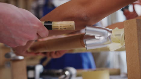 close up of multi-cultural team in workshop assembling hand built sustainable bamboo bicycle frame