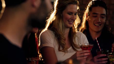 Friends-toasting-drinks-together-in-bar