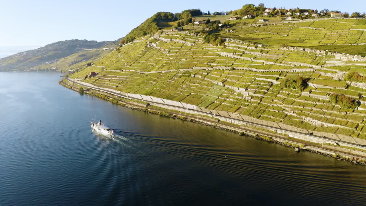 Flying high and going away from CGN Belle-Epoque steam boat on lake Léman in front of Lavaux vineyard, Switzerland Sunset light and autumn colors