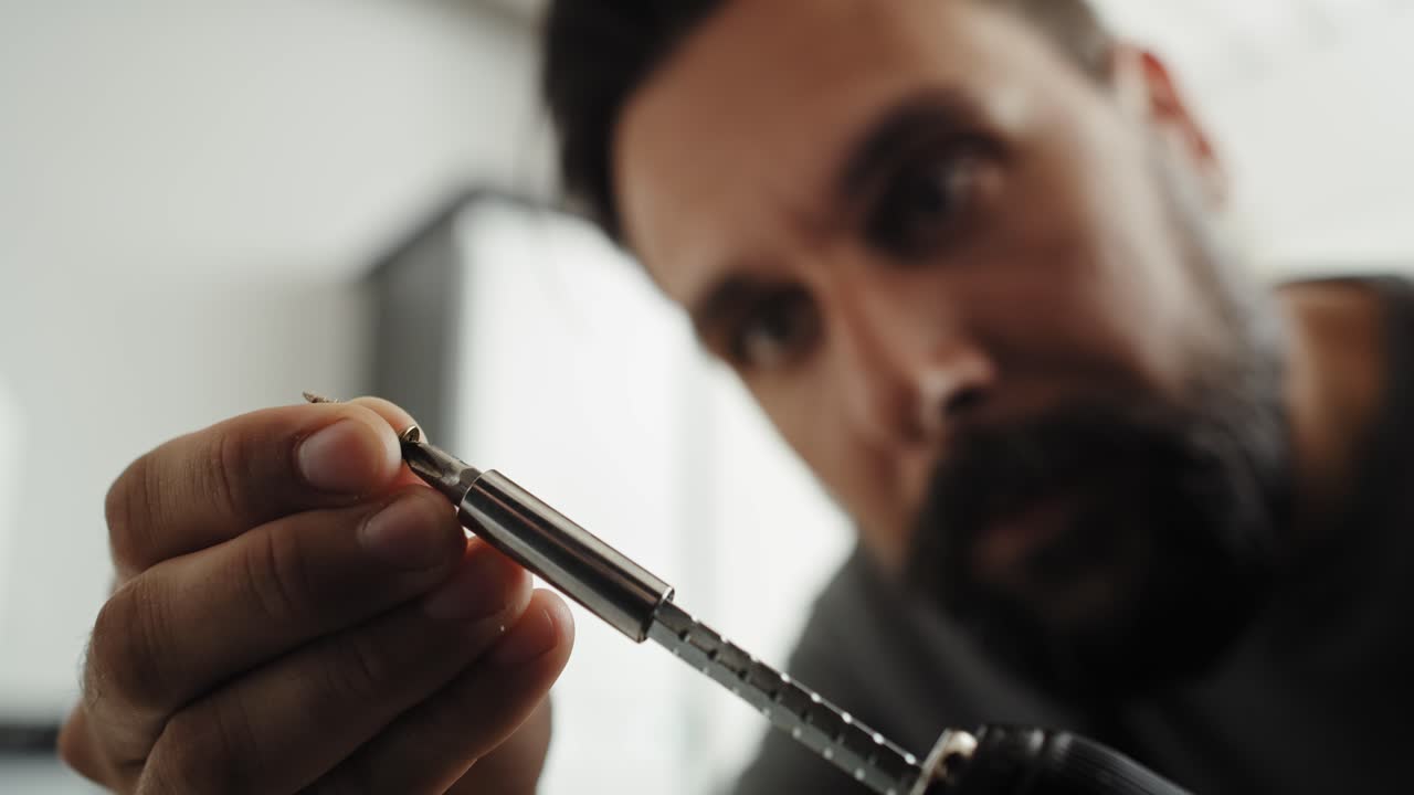 Close up video of screwing hinges with a cordless screwdriver