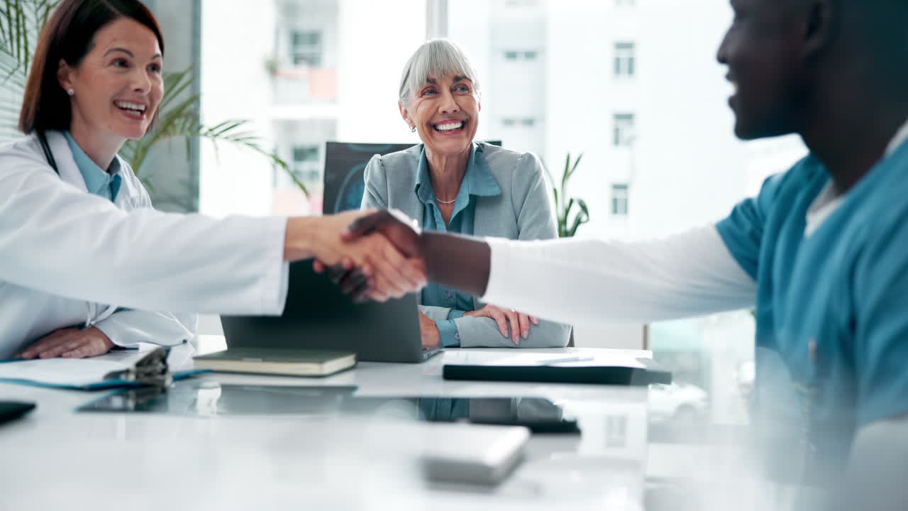 Doctors and patient shaking hands during a meeting