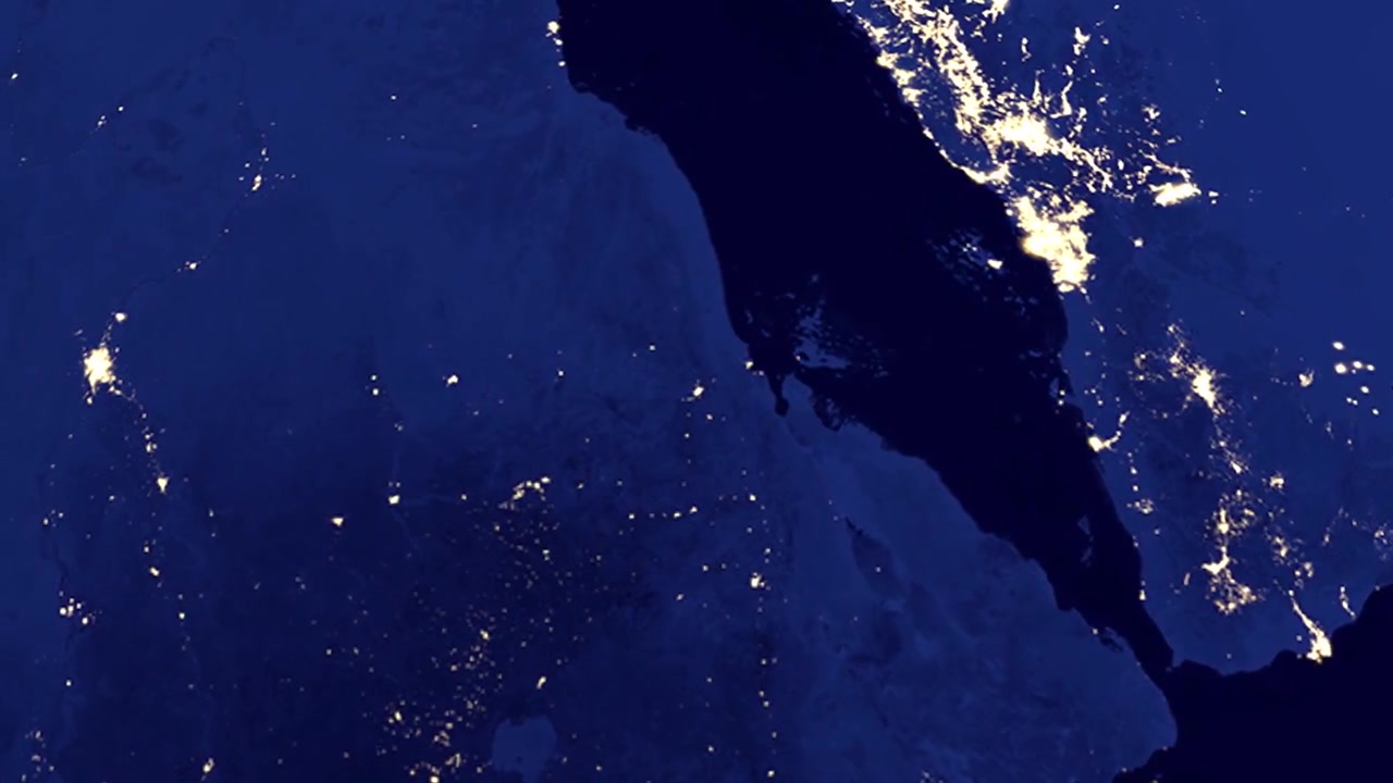 Un'animazione digitale zooma dallo spazio esterno a una vista notturna di Asmara, Eritrea con un indicatore