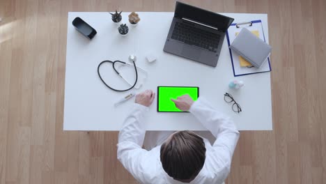 doctor reading electronic medical documentation on tablet with pre-keyed screen