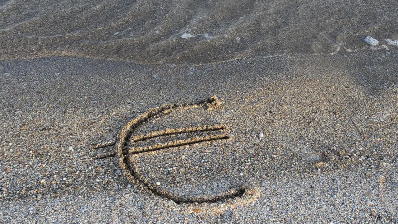 Euro sign on sand. Sand and currency