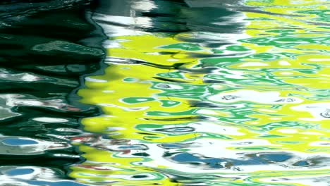 detail of boat with reflections in the sea.