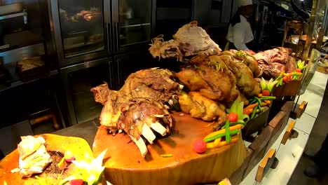 a pile of cooked steaks chicken and ribs