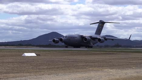 boeing c-17a globemaster iii plane taking off the runway at airport