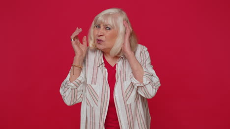 woman trying hear you, looking confused and frowning, keeping arm near ear for louder voice, repeat