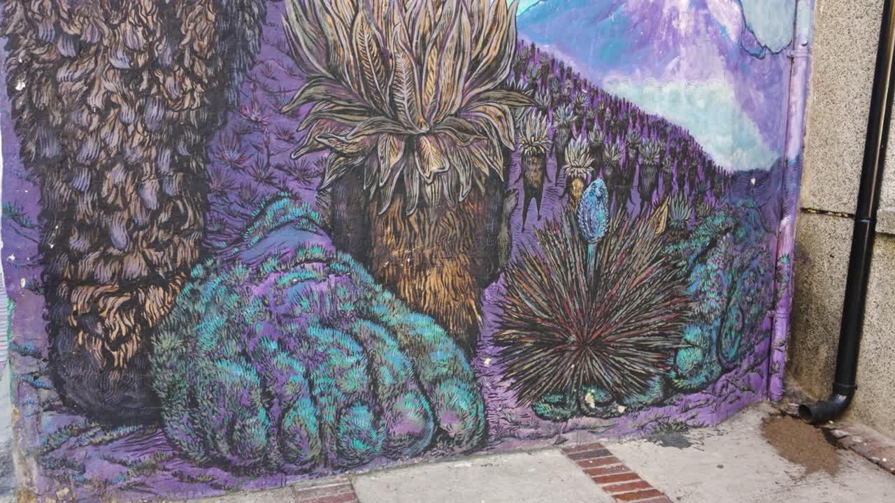 Vibrant Street Art Mural of a Fantasy Landscape with Mountains, Frailejones, and a Mythical Bird