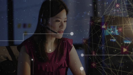 Animation-of-digital-data-processing-over-asian-businesswoman-using-phone-headset