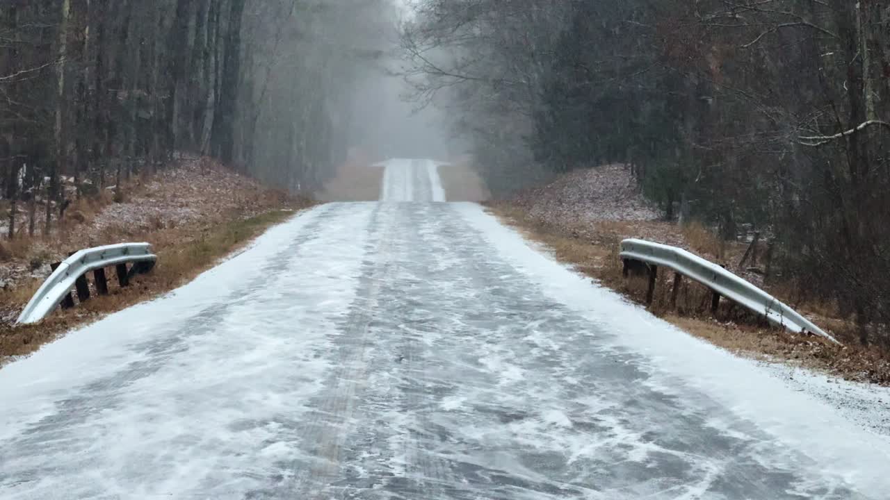 Heavy snowfall on a remote, beautiful forest road during a nor'easter