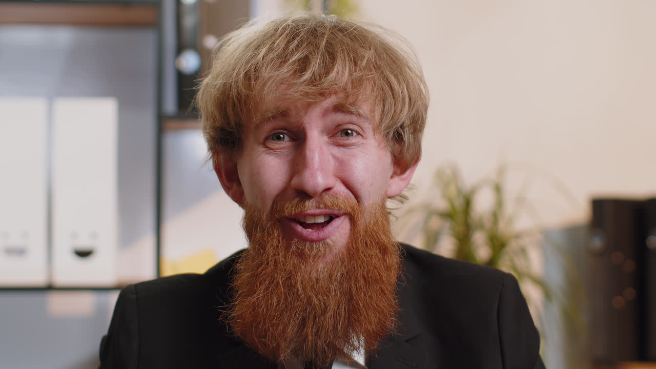 Businessman working at home office taking off glasses shocked by sudden victory lottery winning