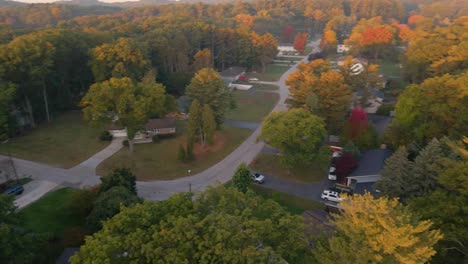 Spinning-around-the-yellow,-orange,-and-red-leaves-during-Autumn-in-Norton-Shores