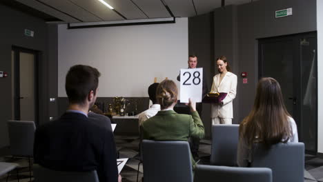 people in an art auction session