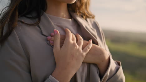 Gentle-woman-hands-adjusting-stylish-clothes-cold-weather-closeup.-Model-posing