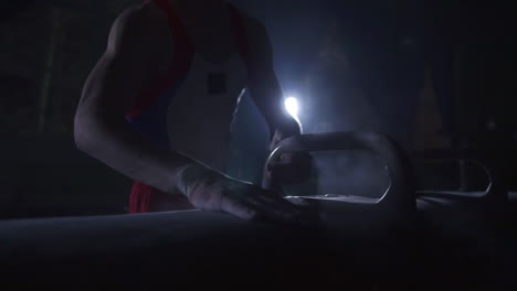 close - up of pommel horse on a dark background and smoke in slow motion male hands magnesia. preparation for the performance. olympic games