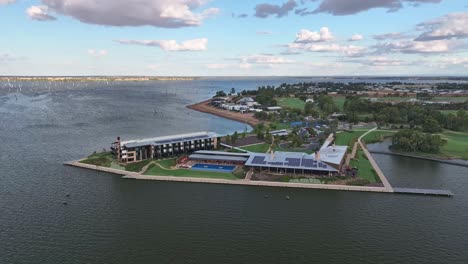 aerial of the sebel hotel and the dead trees in lake mulwala and the beautiful late sun in the distance