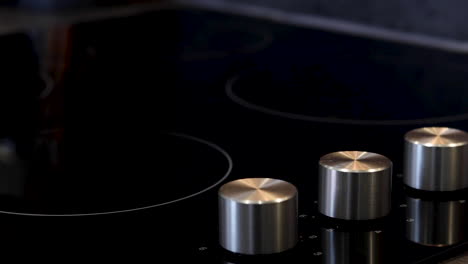 a electric stove or hob being turned on by a knob