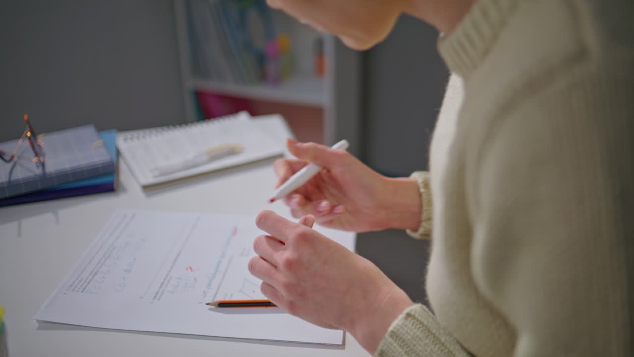 Teacher hands putting marks apartment closeup. Unknown woman correcting homework
