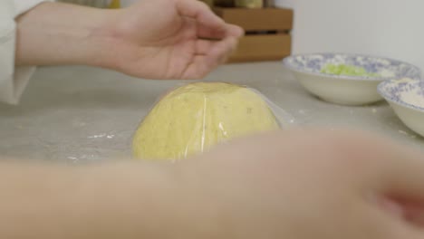 covering lasagna dough for resting on kitchen cooking table