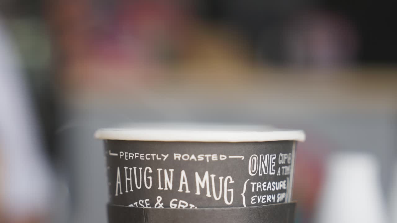 Perfectly roasted hot coffee in single use mug, close up static view