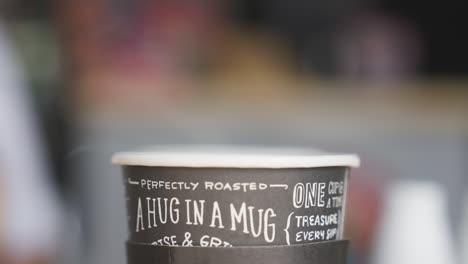perfectly roasted hot coffee in single use mug, close up static view