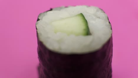 Sushi-roll-rotating-on-rosy-background