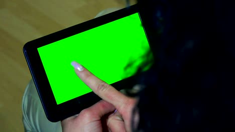 business woman holds a blank tablet pc in with a green screen for your own custom content. uhd stock video, luma matte included.