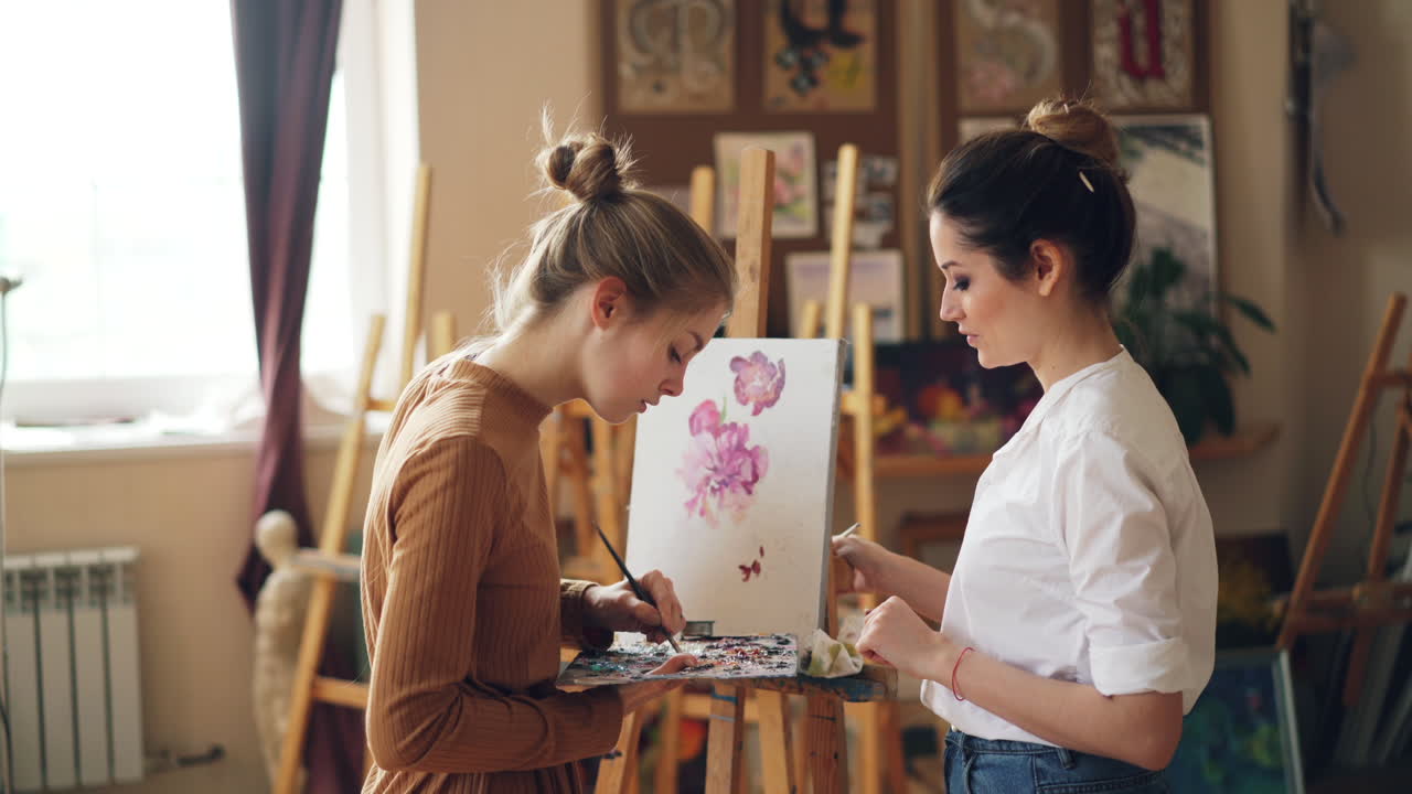 Two Women Painting Flowers in an Art Studio