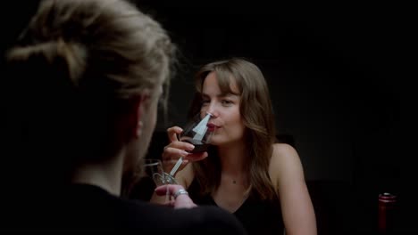 two women enjoying a glass of red wine together