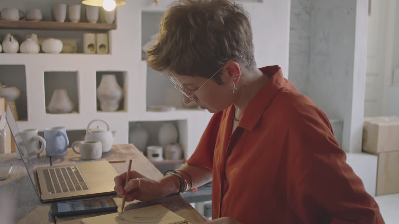 Woman Drawing Sketch in Pottery Workshop