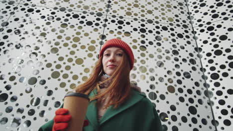 woman with coffee in city