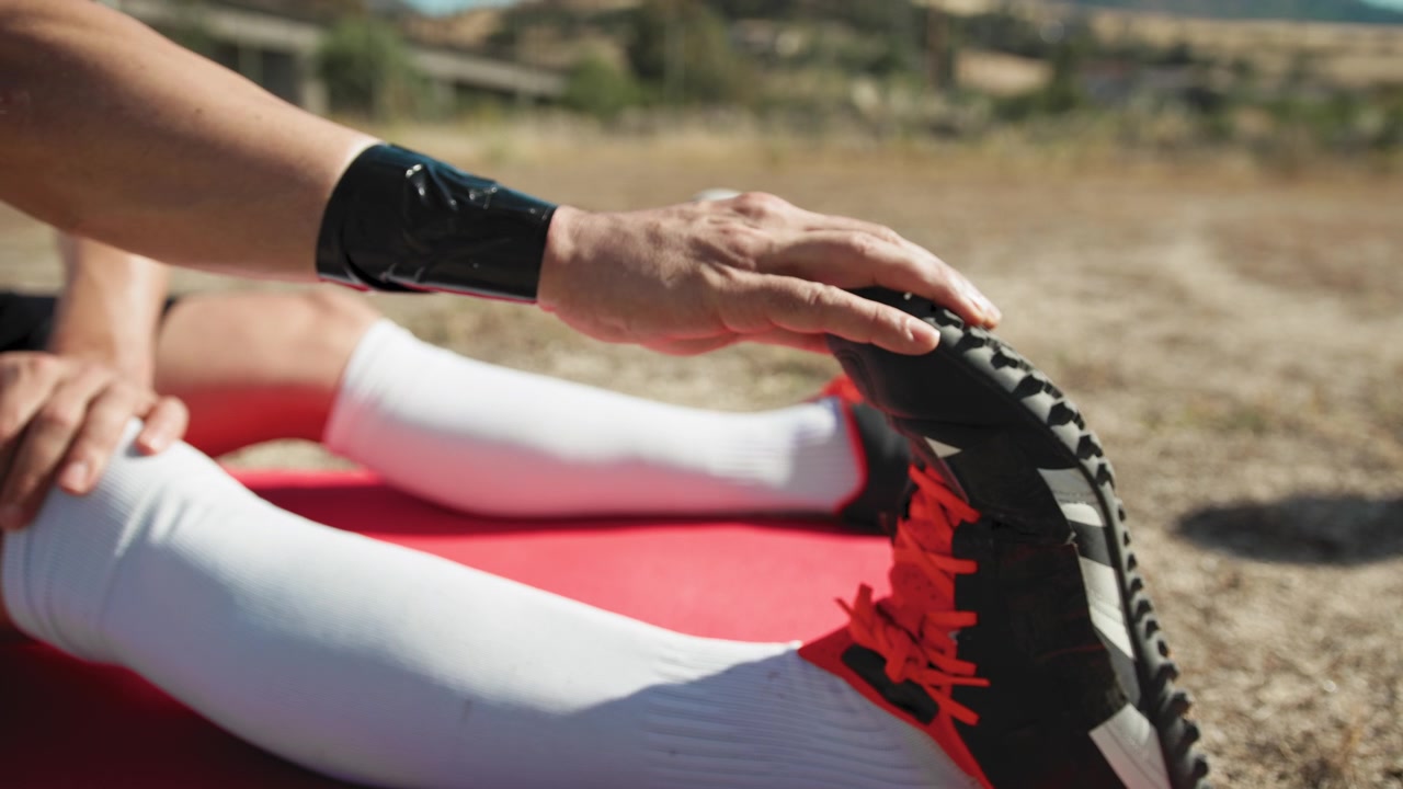 Hand Of A Soccer Player On The Boots During Stretching, Close Up