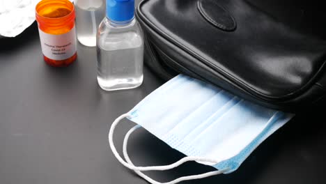 travel kit with face mask, hand sanitizer, and medicine