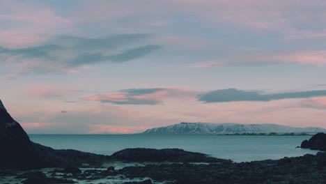 iceland beach at dawn with pink clouds, panning timelapse