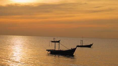 boats gently float on a golden sea