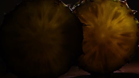 comosus pineapple ananas slices in a dark