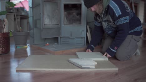 a man is involved in the craft of working with firebricks in indre fosen, trondelag county, norway - close up