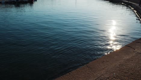 slow revealing shot of chania old venetian port with historic lighthouse with beautiful blue sea water