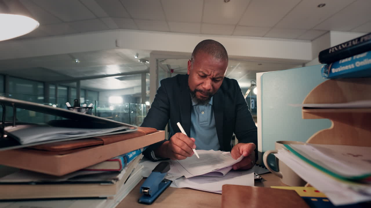 Night, books and business man writing in office