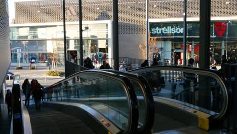 shopping mall with escalators and retail stores