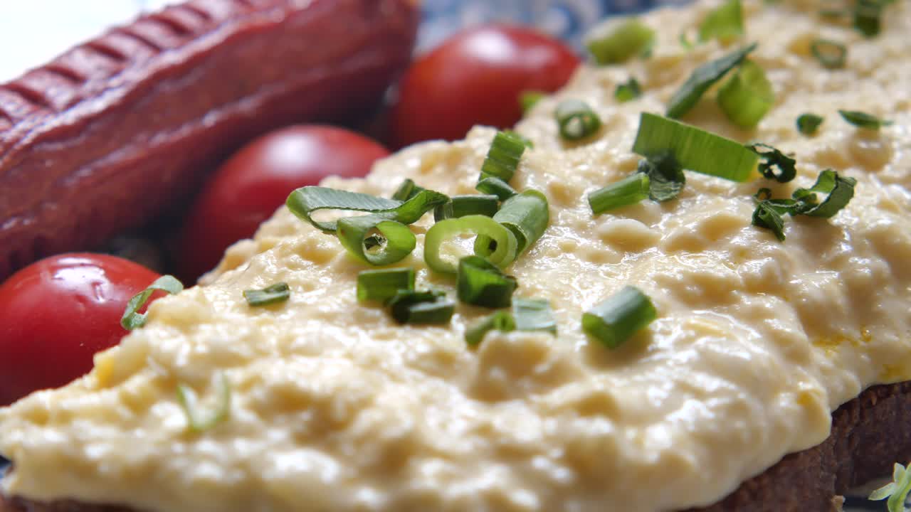 Scrambled Eggs on Bread with Sausage and Tomatoes