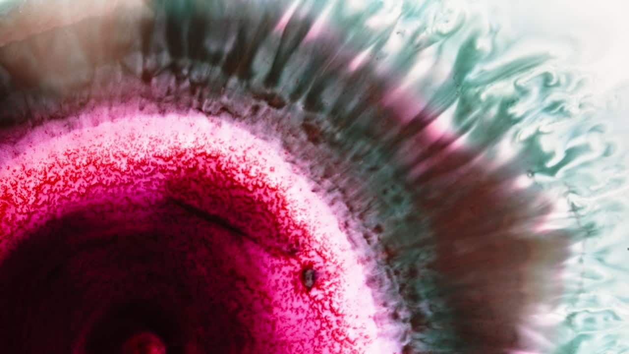 Abstract ink patterns swirling, close-up macro shot revealing vivid color movements