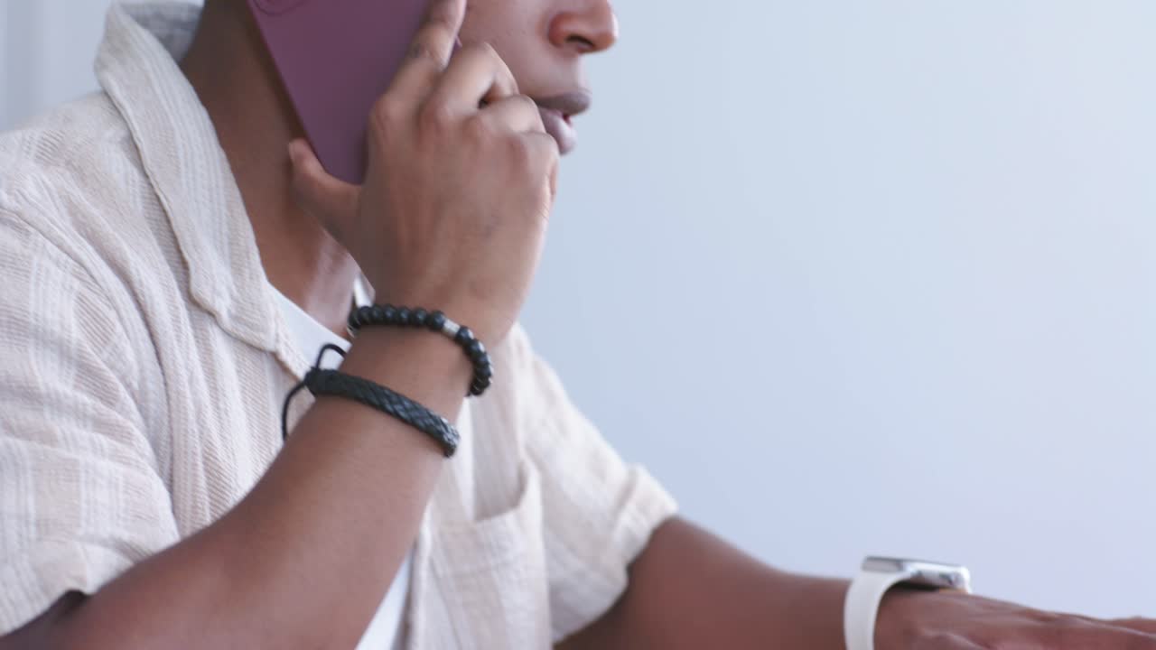 Worker typing on laptop, lifting purple phone, answering business call with animated bubbles