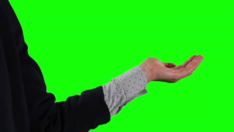 Side-view-of-Caucasian-woman-holding-her-hand-for-copy-space-with-green-screen