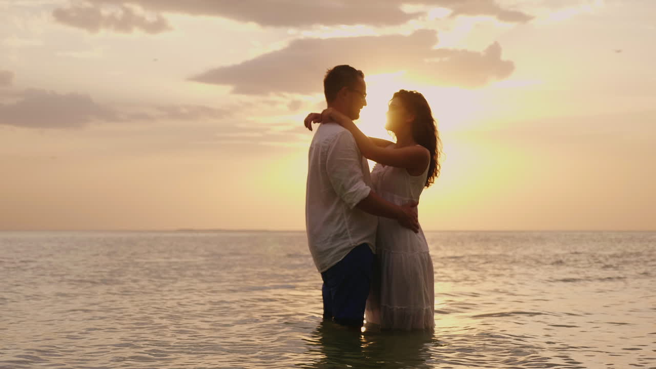 Young Couple In Love Standing In The Sea At Sunset Looking At Each Other Hd  Video Free Stock Video Footage Download Clips Water