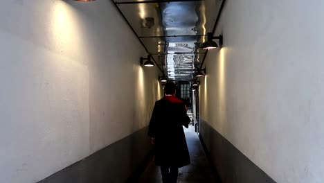 Man dressed like Harry Potter pulls out magic wand and walks alley with it pointing up