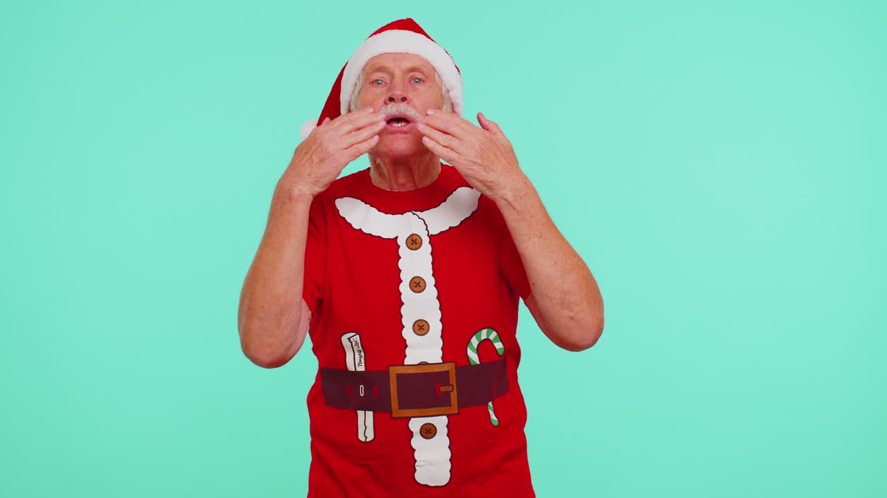 Senior christmas grandfather sending lots of air kisses looking at camera smiling missing you love